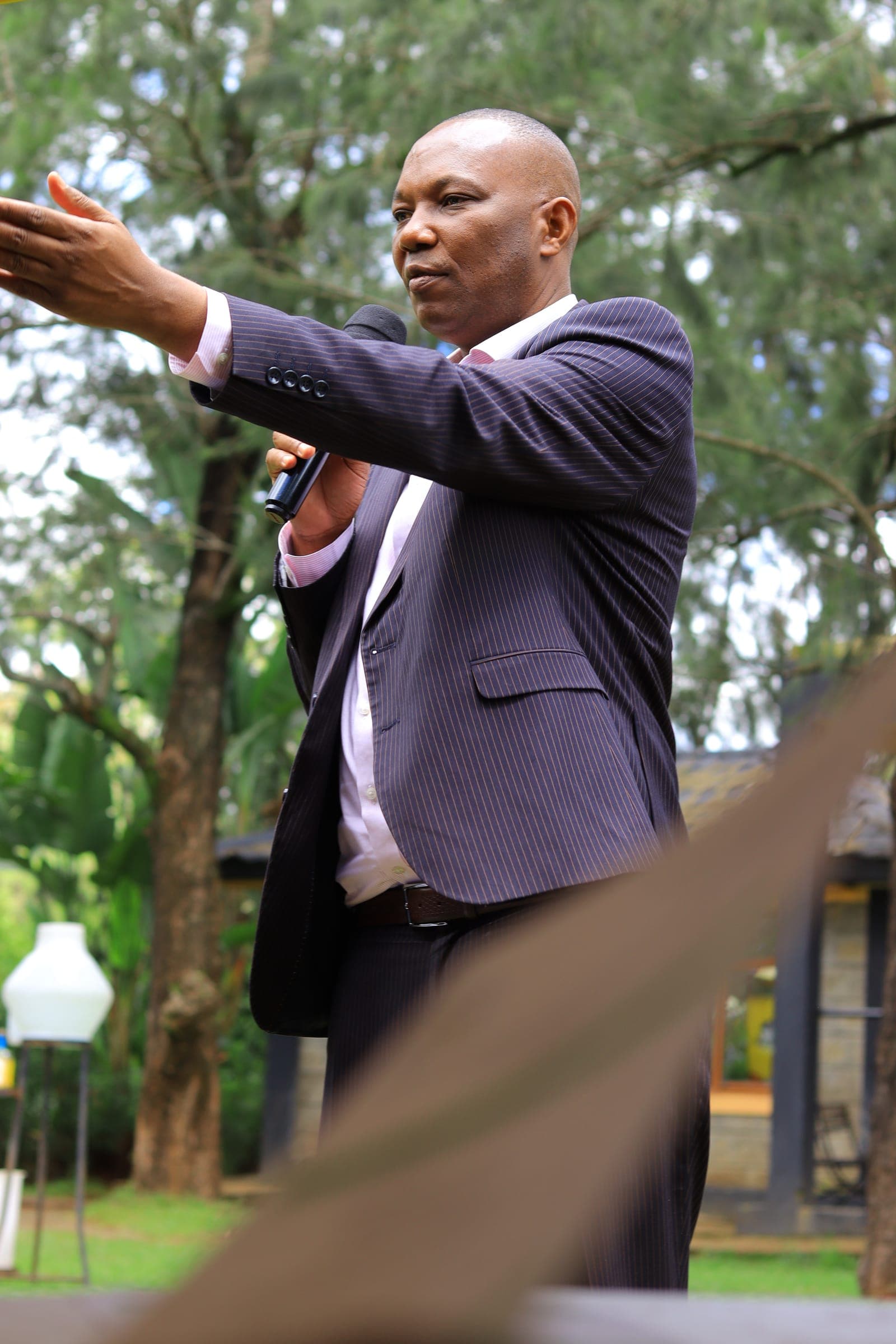 PPOK Chairman Evans Misati gesturing towards the audience while speaking outdoors