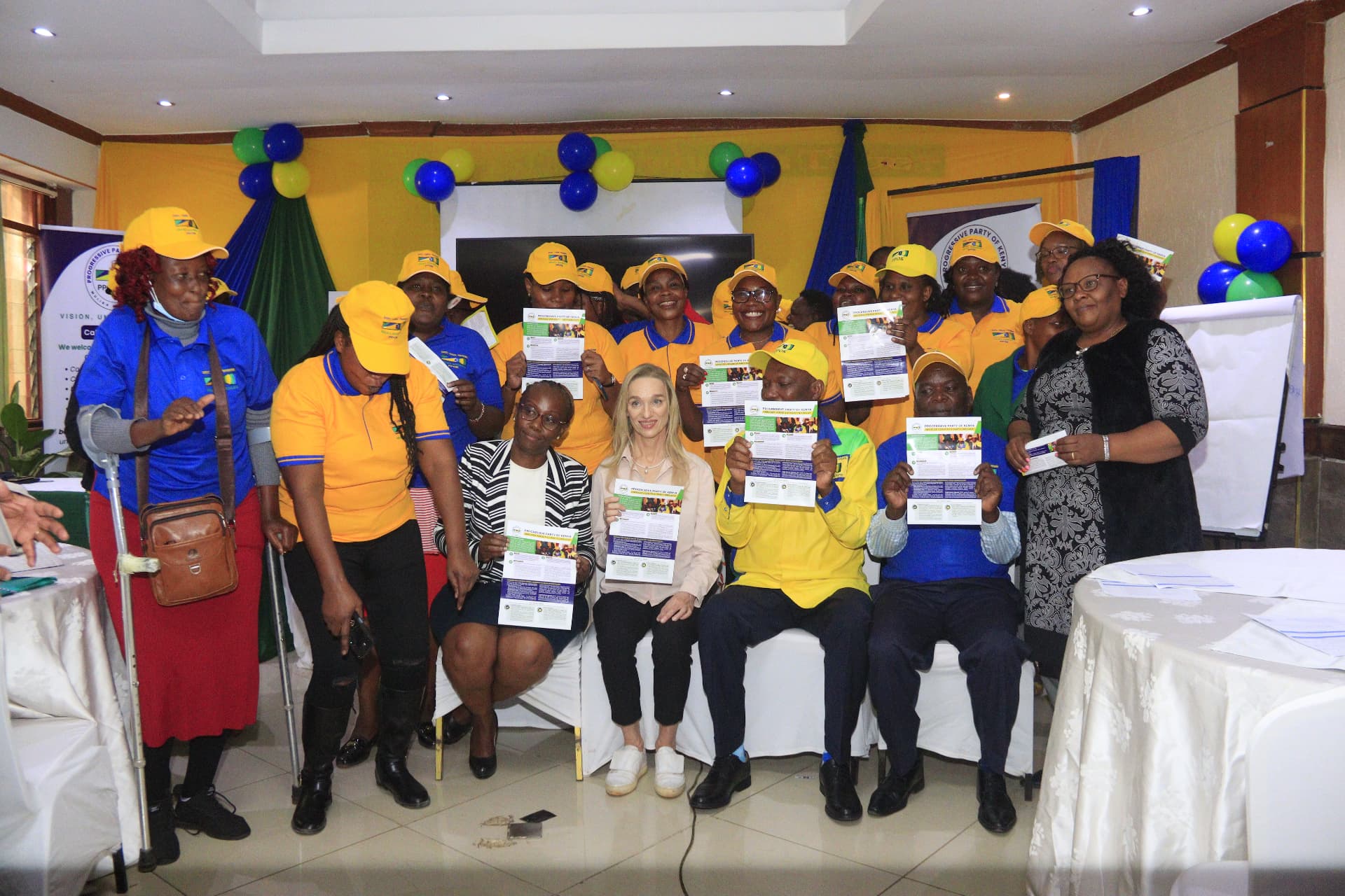 PPOK women members holding party flyers at a forum